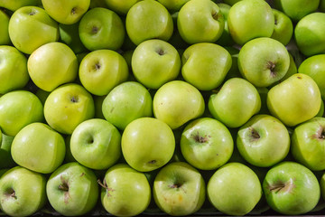 Green apple pile put together looking from the top view at market
