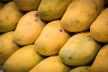 close up Mangoes pile put together have pattern in front of shop at market