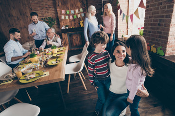 Close up photo of gathered relatives in decorated home house din