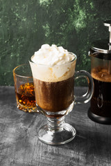 Irish coffee with whisky on dark background