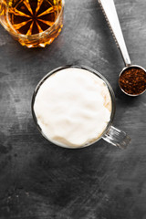 Irish coffee with whisky on dark background. Top view, copy space. Food background