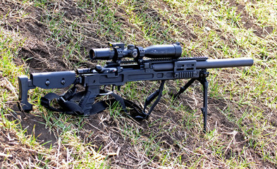 combat rifle with sniper scope is on the ground, Ukraine and Donbass conflict