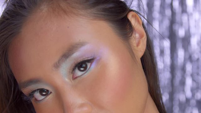 closeup of asian eye makeup uses rainbow holographic eyeshadows