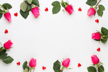 Flowers composition. Frame made of red rose on white background. Flat lay, top view, copy space.