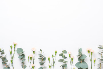 Flowers and eucaaliptus composition. Pattern made of various colorful flowers on white background. Flat lay stiil life.