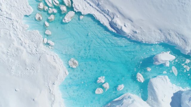 Antarcica Iceberg Turquoise River Top Down View. Nature Lake with Blue Water and Broken Ice Flow. Ecology, Melting Ice, Climate Change and Global Warming Concept Aerial Drone Shot Footage 4K (UHD)
