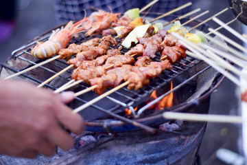 Steak and sauce on the table with dipping sauce on the meat, decorated with vegetables and french fries blurred photo