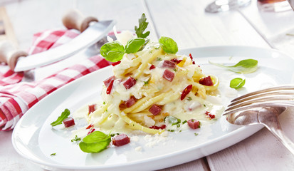 Plated Italian spaghetti pasta with diced ham