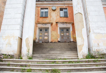 old damaged building with columns and steps
