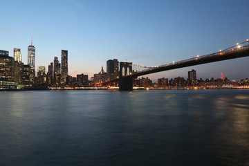 Naklejka na ściany i meble View from the sea on the evening of New York and the bridge