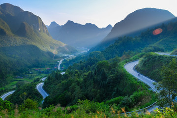 Motorbikers on winding roads through valleys and karst mountain scenery in the North Vietnamese...