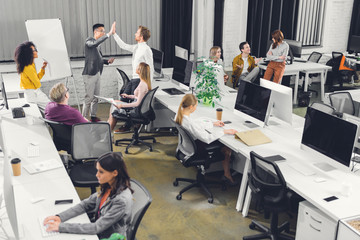 high angle view of professional multiracial business people working together in open space office
