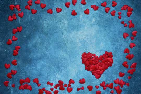 Valentines Day background. Red hearts frame on dark blue background. Copy space, top view.