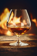Snifter with French cognac in front of a fire