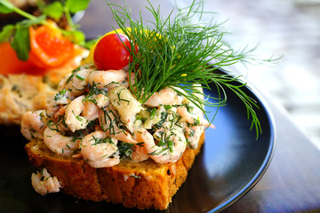 Scandinavian Smorrebrod open-faced sandwich with cold shrimp in Denmark 