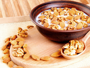 Healthy food. Walnuts and almonds with milk.