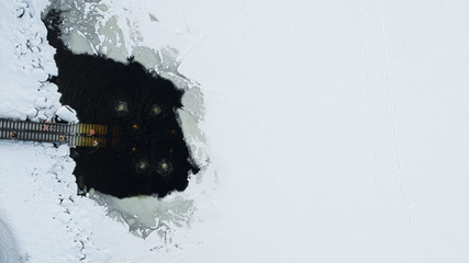 People are swimming in huge ice hole after sauna. Ice swimming. 