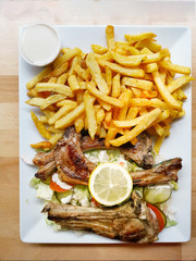 Delicious three grilled lamb chops served with fresh lettuce, tomatoes and homemade French fries.