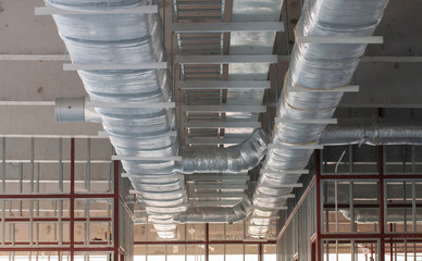 Typical installation of ducting with fiberglass insulation work combine with cable tray and fire fighting pipe