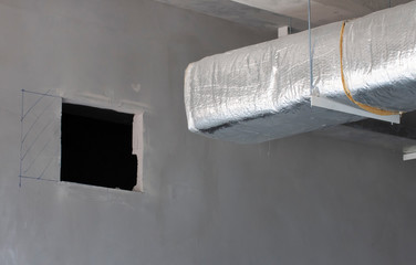 Typical installation of ducting with fiberglass insulation work combine with cable tray pass through to the wall