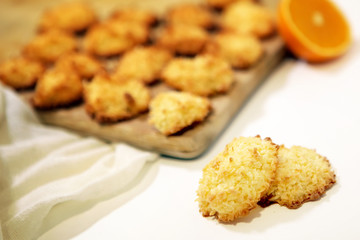 coconut bisquits on a wooden dish and white background