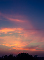 Clouds glowing after the sun has set in the horizon, creating a beautiful and vibrant sky after sunset
