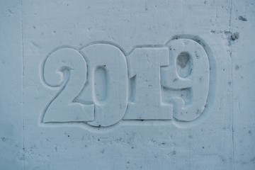 Abstract New Year's and Christmas background on snow 2019. Ice figure in the shape of numbers 2019.