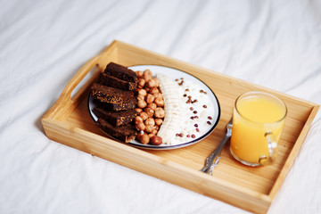 Delicious and healthy Breakfast and juice in a white bed, close-up