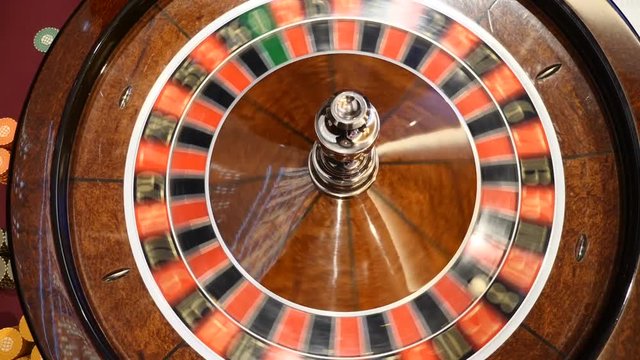 Casino concept. Top view on roulette in motion, white ball spinning. Bad luck and Good luck concept. Roulette wheel running. City nightlife entertainment. hd