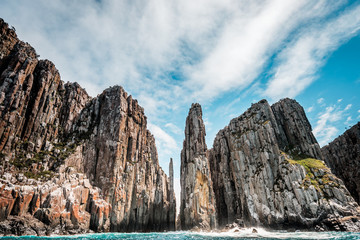 View to the Totem Pole of Cape Hauy, rough coastline with dolerite cliffs, Tasmania, Australia