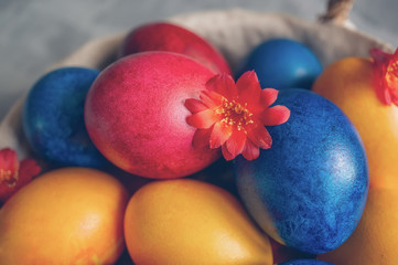 Colorful easter eggs lying in a basket on a beautiful vintage background. View from above. Easter Brunch