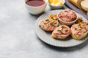 Breakfast on the table. Chicken pate and butter sandwiches. Cup of tea