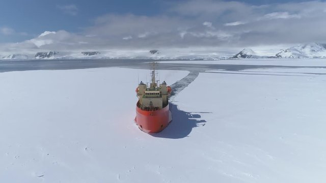Antarctica Icebreaker Vessel Front Aerial View. Laurence M. Gould Research Boat Break Through Southern Ocean Glacier at Frozen Polar Coast Top Tracking Drone Shot Footage 4K (UHD)