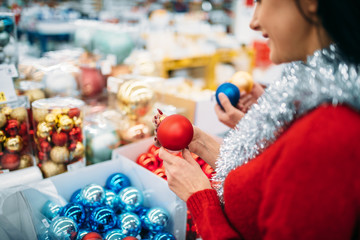Fototapeta na wymiar Female person buying christmas tree balls