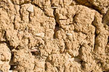 Old wall plastered with mud closeup