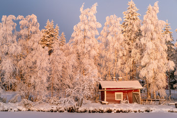 Red little winter cabin Finland