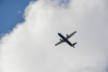 Passenger airplane landing against blue cloudy sky in Brazil