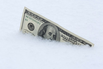 one hundred dollars banknote in snow