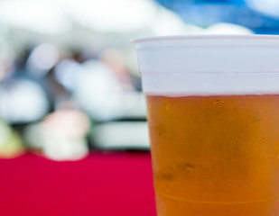 Close up of a fresh cup of beer in a plastic cup.