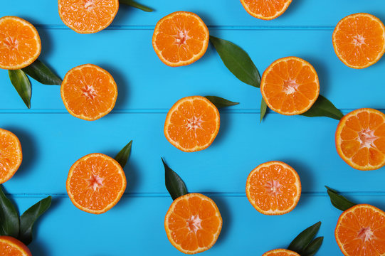 tangerines with green leaves on turquoise  background.