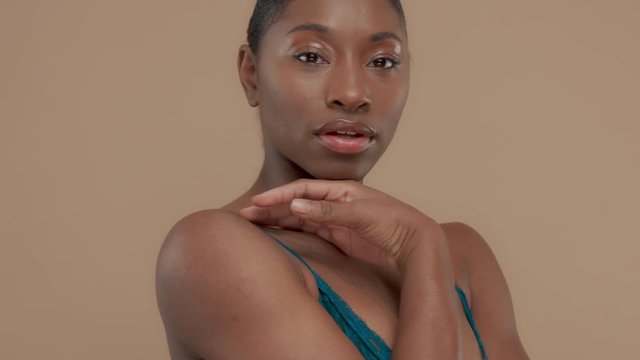 closeup black mixed race model portraitin studio natural makeup gloss eylid neutral makeup