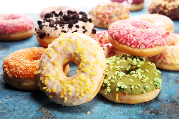 assorted donuts with chocolate frosted, pink glazed and sprinkles