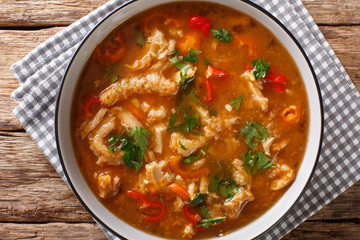 Flaki or flaczki is a traditional Polish meat stew close-up in a bowl. horizontal top view