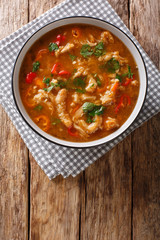 Polish national cuisine. flaczki with vegetables in tomato sauce close-up in a bowl. Vertical top...