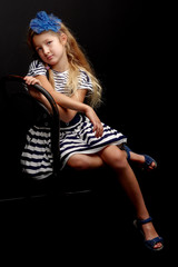 Little girl on a black background
