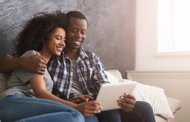 Happy couple using tablet