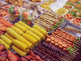 Street food on sticks in Phuket (Thailand). Corn cobs, pork, chicken, shrimp and other food.