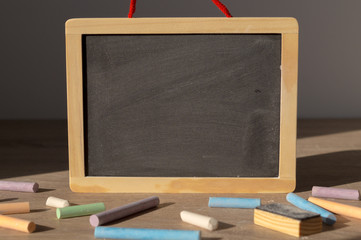 Clean blackboard and colorful chalks.