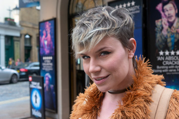 Portrait of a young woman in front of a theater.