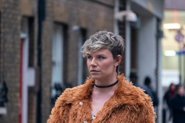 Portrait of a young woman walking down the street
